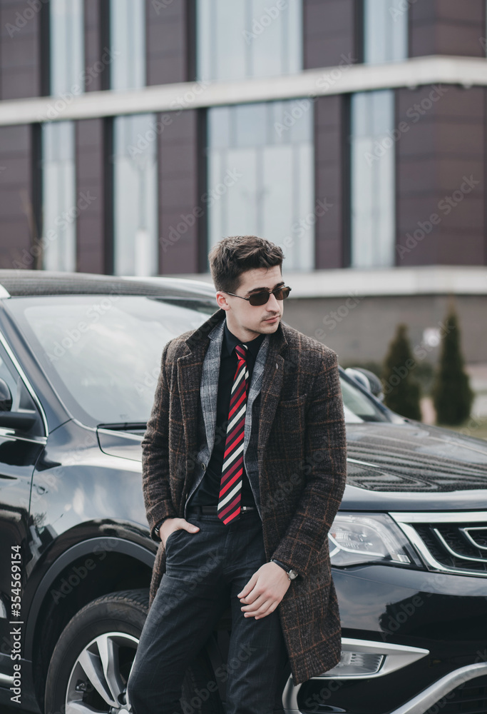  businessman in glasses standing near automobile