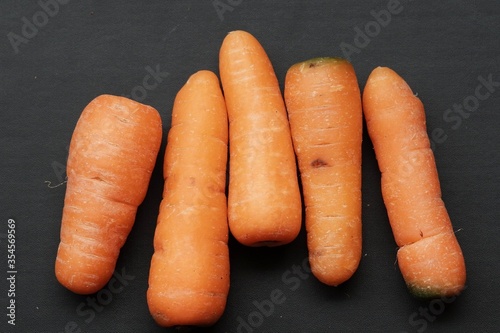 baby carrots on black isolated background photo
