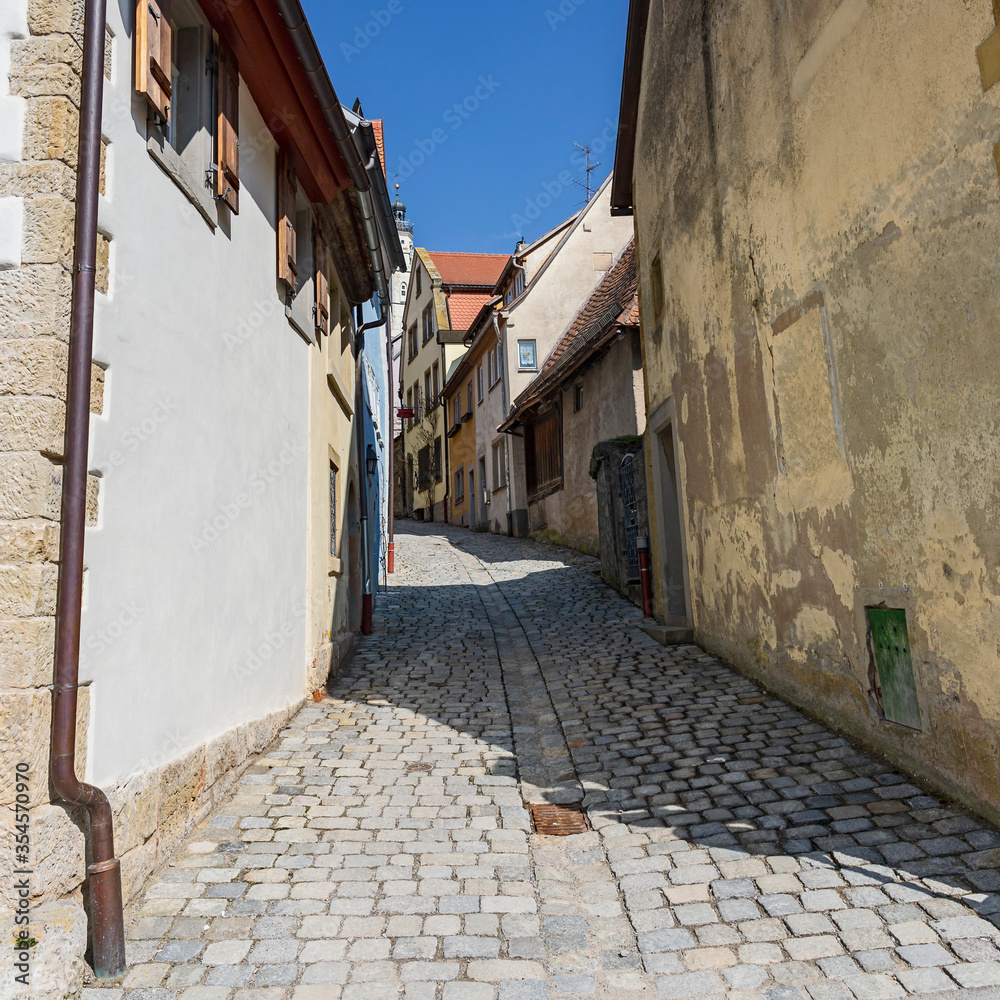 narrow cobbled street with old houses in the old German town of Rothenburg ob der Tauber