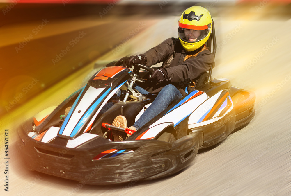 Woman driving sport car for karting  in a circuit lap outdoor in