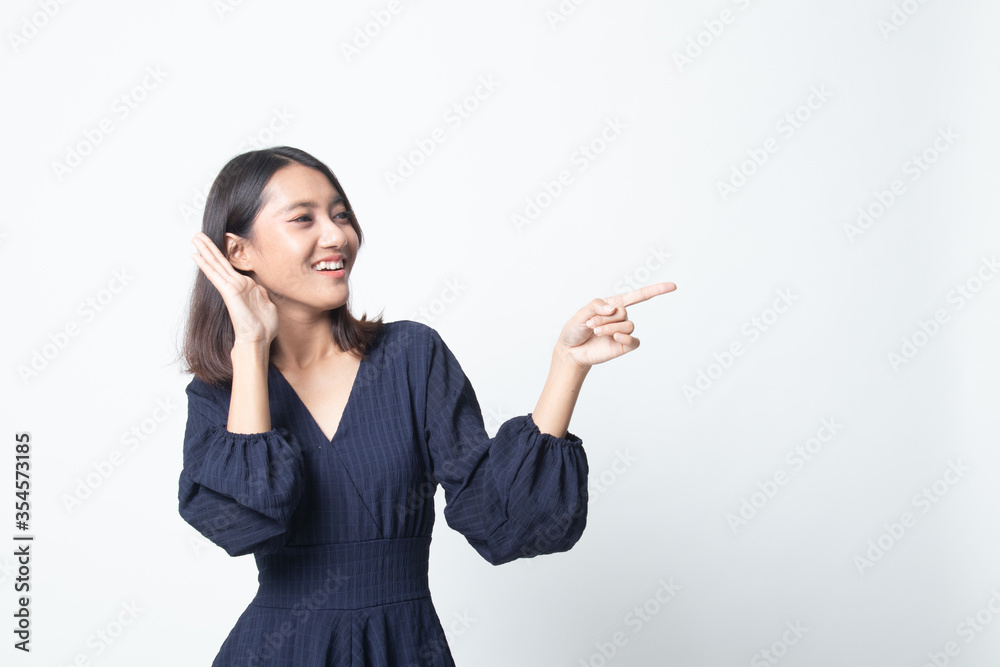 Excited Asian woman point to blank space. Excited Asian woman point to blank space.