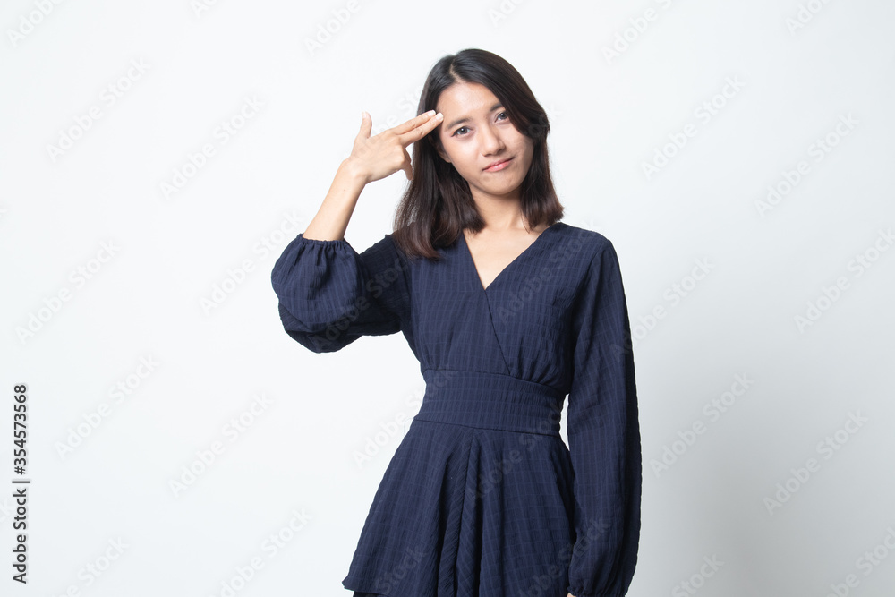 Beautiful young Asian woman holding fingers in gun gesture. Beautiful young Asian woman holding fingers in gun gesture.