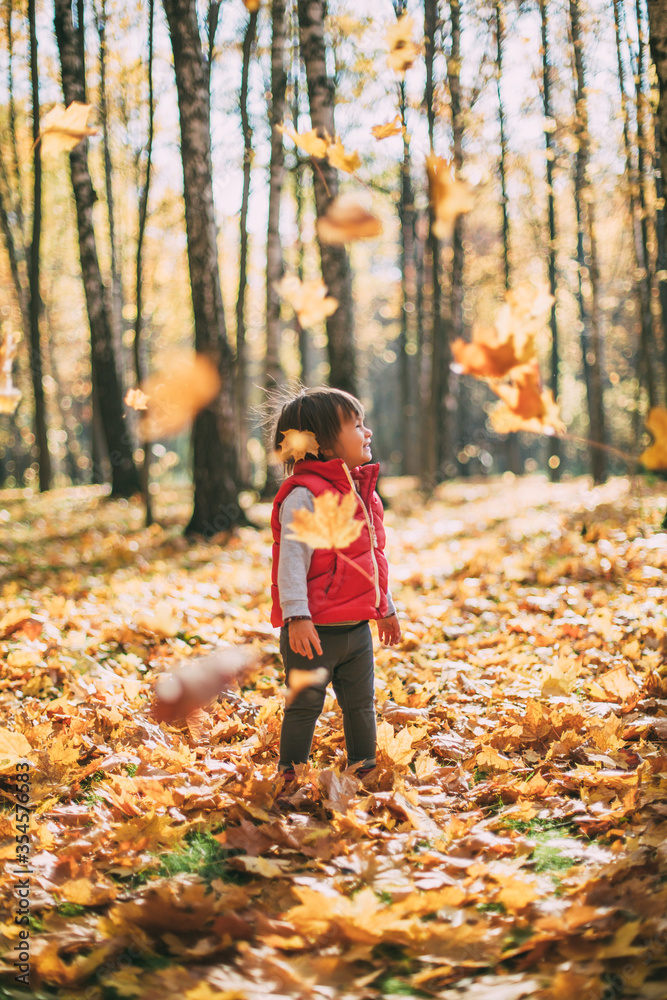 little beautiful girl loves autumn, walks in autumn forest and smiles little beautiful girl loves autumn, walks in autumn forest and smiles