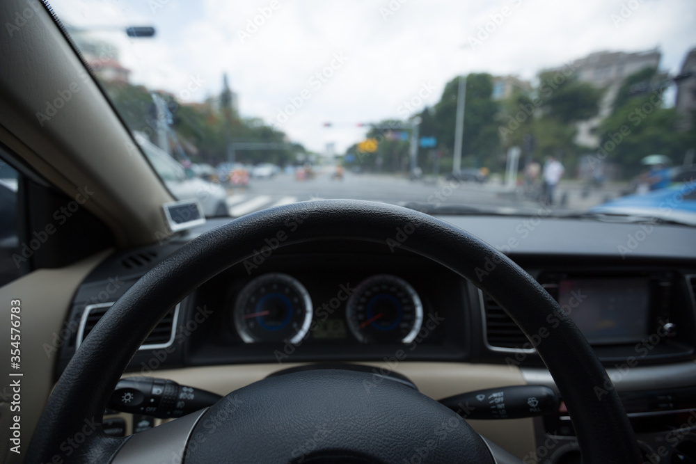 Driving car on city road awaiting in front of the zebra crossing