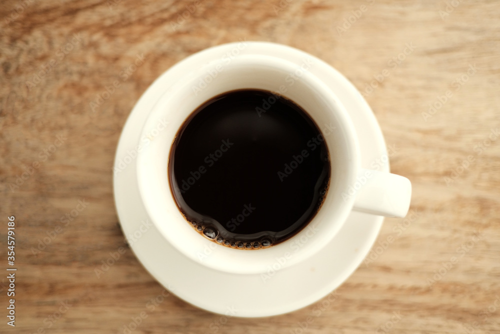 cup of coffee on wooden table cup of coffee on wooden table