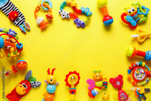 Baby kids toys on yellow background. Top view