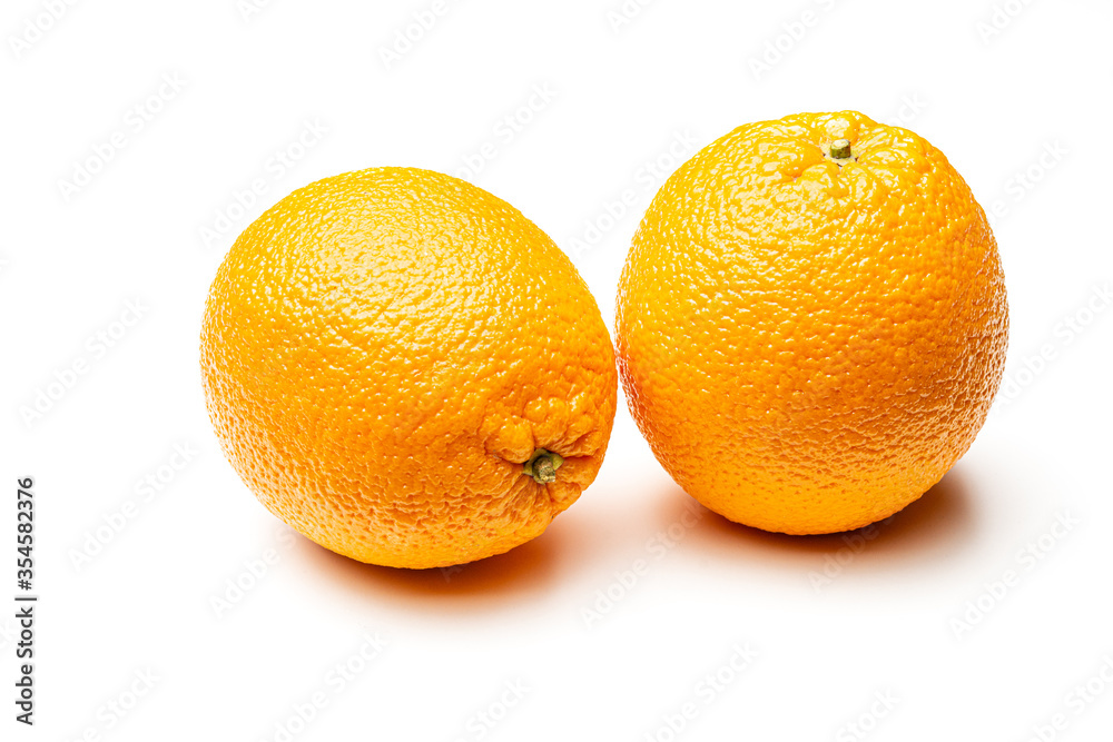 Two ripe oranges on a white background. Isolate Yellow orange. Two ripe oranges on a white background. Isolate Yellow orange.