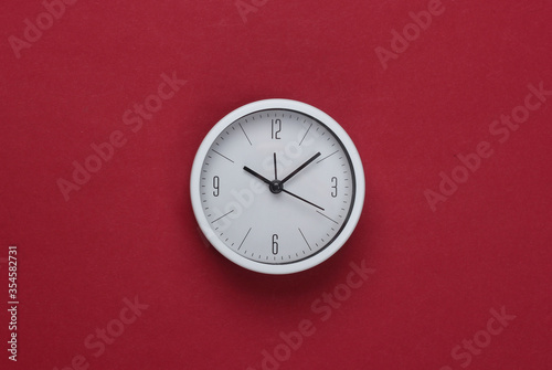 Wallpaper Mural White clock on red background. Minimalistic studio shot. Top view Torontodigital.ca