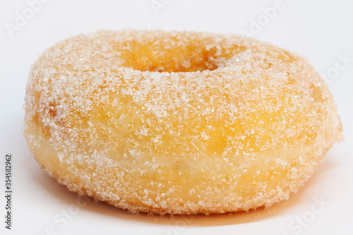 a donut with lots of sugar on white background