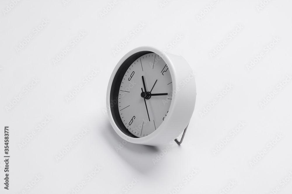 White clock on white background. Minimalistic studio shot. White clock on white background. Minimalistic studio shot.