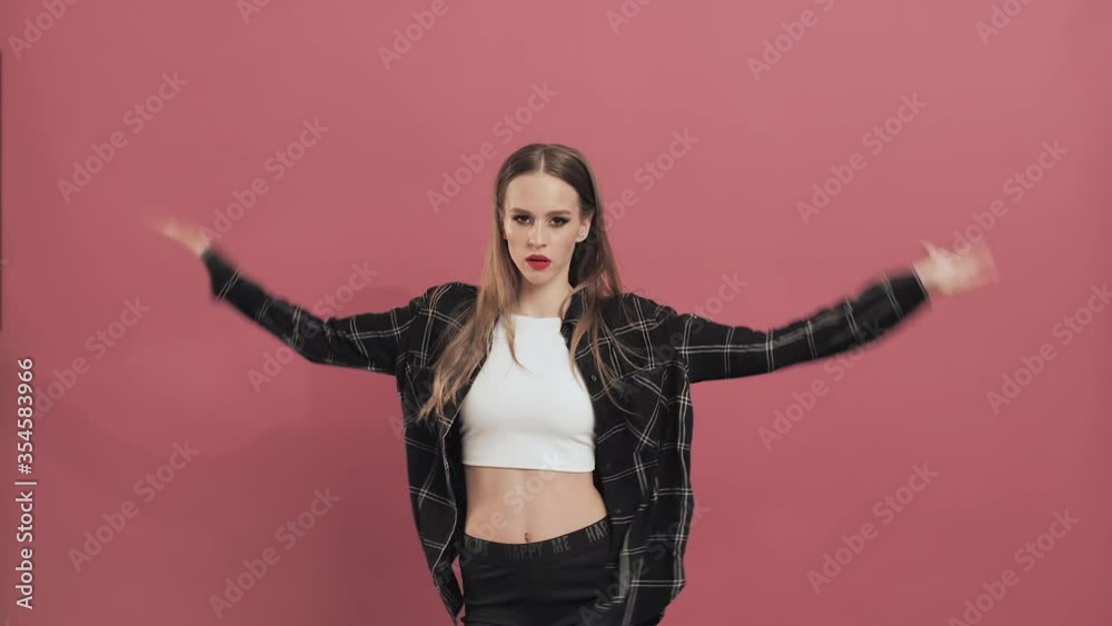 Beautiful Young Woman with Long Hair Having Fun Smiling and Dancing in Studio. Teenage Girl Dancing Shaking Her Head Slow Motion Success, Party, Holiday Concept Beautiful Young Woman with Long Hair Having Fun Smiling and Dancing in Studio. Teenage Girl Dancing Shaking Her Head Slow Motion Success, Party, Holiday Concept