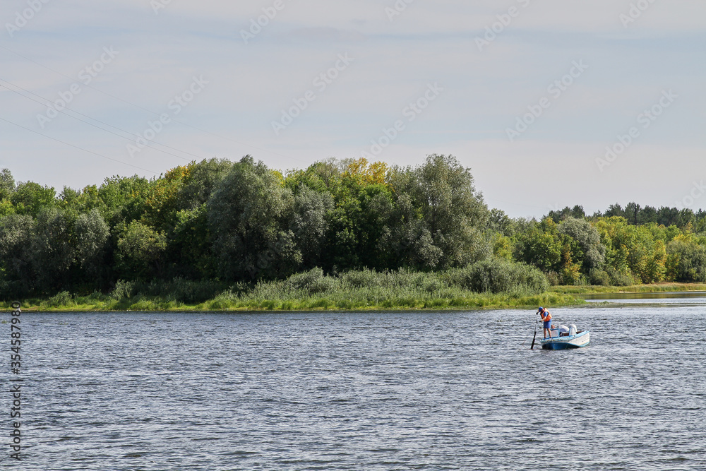 Rescuers on the river in a motor boat in the summer in Belarus. Rescuers on the river in a motor boat in the summer in Belarus.