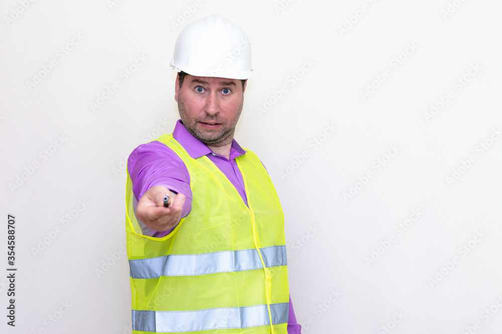 Portrait middle age of caucasian worker wearing hard hat holding pen makes all kinds of grimaces on white studio background. Portrait middle age of caucasian worker wearing hard hat holding pen makes all kinds of grimaces on white studio background.