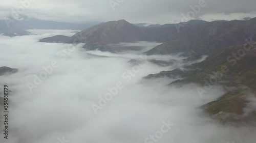 Wallpaper Mural View from the drone and the height of the bird's flight on the mountains above the clouds. The camera rotates 360 degrees. There are clouds above the mountains too Passionate Torontodigital.ca