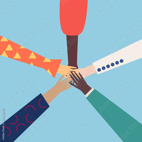 Hands of diverse group of people holding hands together. Concept of cooperation, unity, togetherness, partnership, agreement, teamwork, social community or movement.Top view of hands. 