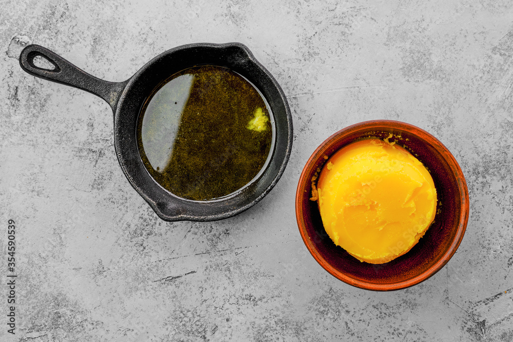 Homemade rustic melted butter and small cast iron skillet Homemade rustic melted butter and small cast iron skillet