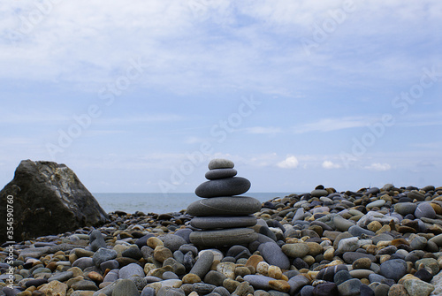 Pyramid of round stones on the seashore  the concept of harmony  balance and meditation.