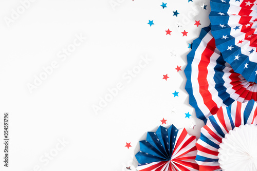 4th of July American Independence Day. Happy Independence Day. Red, blue and white star confetti, paper decorations on white background. Flat lay, top view, copy space photo