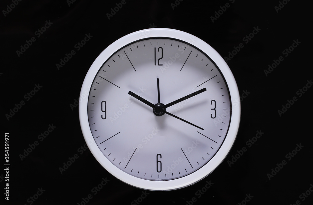 White clock isolated on black background. Time running away. Top view White clock isolated on black background. Time running away. Top view