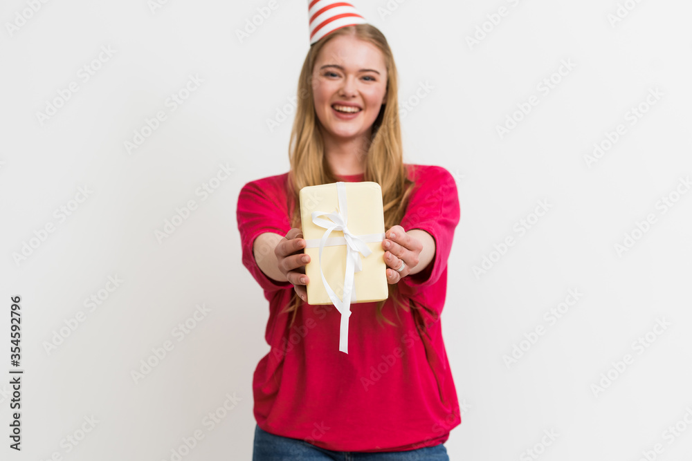 selective focus of happy woman in party cap holding gift box isolated on white selective focus of happy woman in party cap holding gift box isolated on white