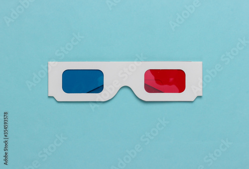 Stereoscopic anaglyph disposable paper 3d glasses on blue background. Top view photo