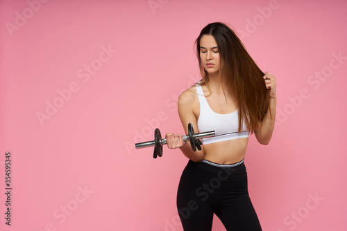  young girl doing fitness on pink background © Paco Sinisterra
