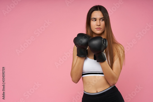  young girl doing fitness on pink background