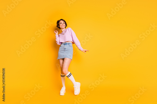 Full length body size view of her she nice-looking attractive lovely slender thin glad cheerful cheery girl dancing isolated on bright vivid shine vibrant yellow color background