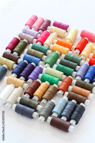 Creative arrangement of colorful threads on a white background