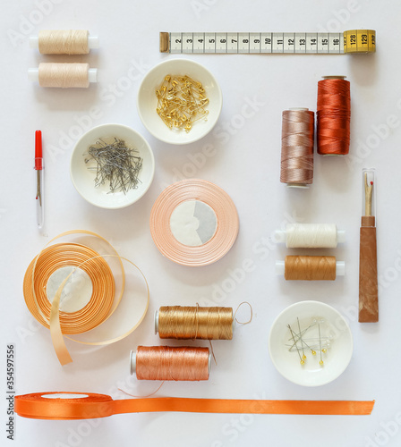 Different sewing accessories arranged neatly on a white background