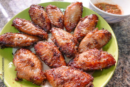 traditional Thai culture fried chicken wing grilled cuisine air fryer or kai tod yang box set famous street fast foods menu at thailand hot spicy sauces on wood sticky rice