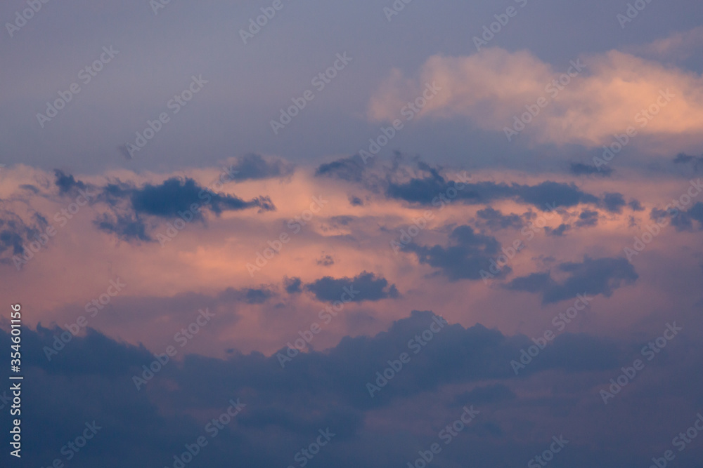 Beautiful dramatic gray and white clouds on blue sky, variety of shapes, silhouettes and shades at sunset time Beautiful dramatic gray and white clouds on blue sky, variety of shapes, silhouettes and shades at sunset time