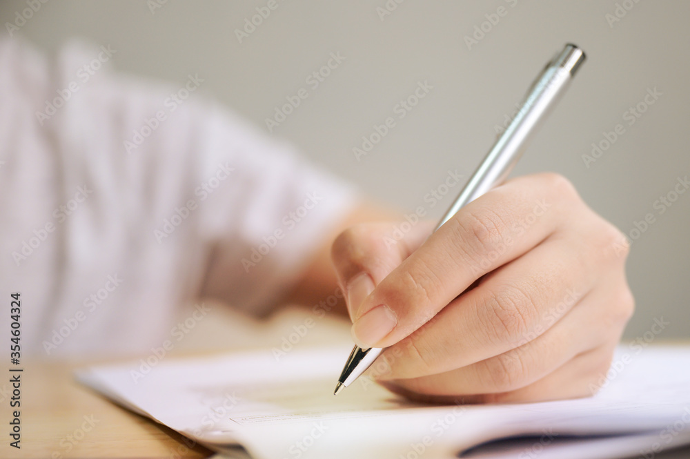 Hand of man signing signature filling in application form document business contract agreement Hand of man signing signature filling in application form document business contract agreement