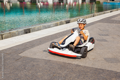 Happy boy riding an electric car