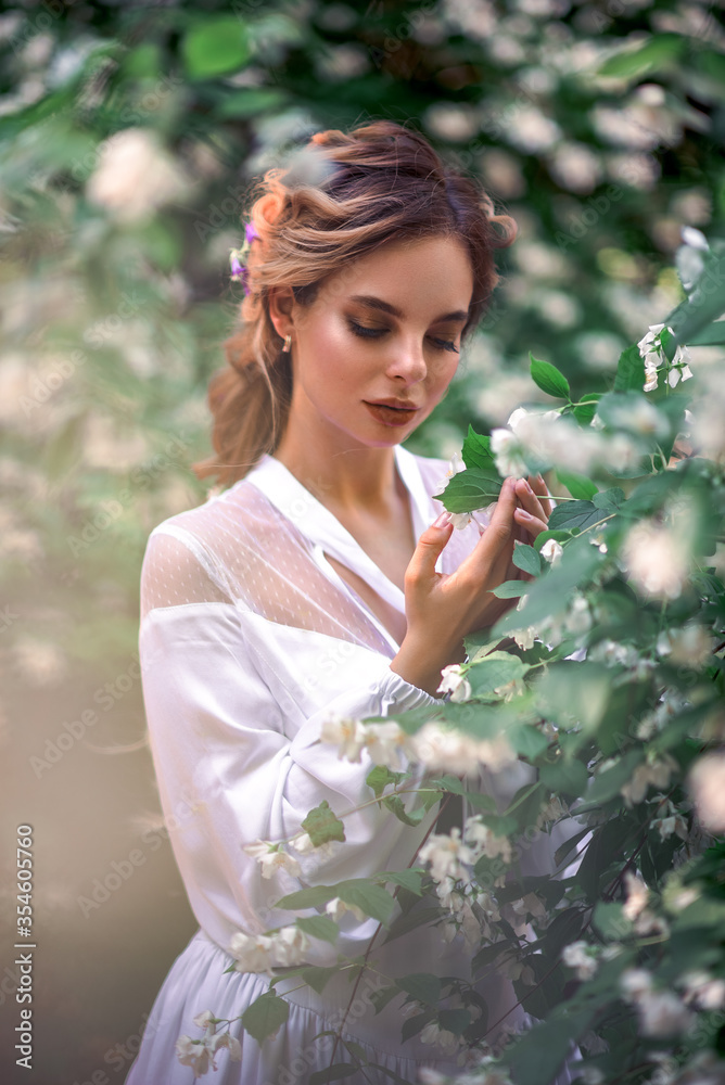 portrait of a young beautiful woman in blooming jasmine portrait of a young beautiful woman in blooming jasmine
