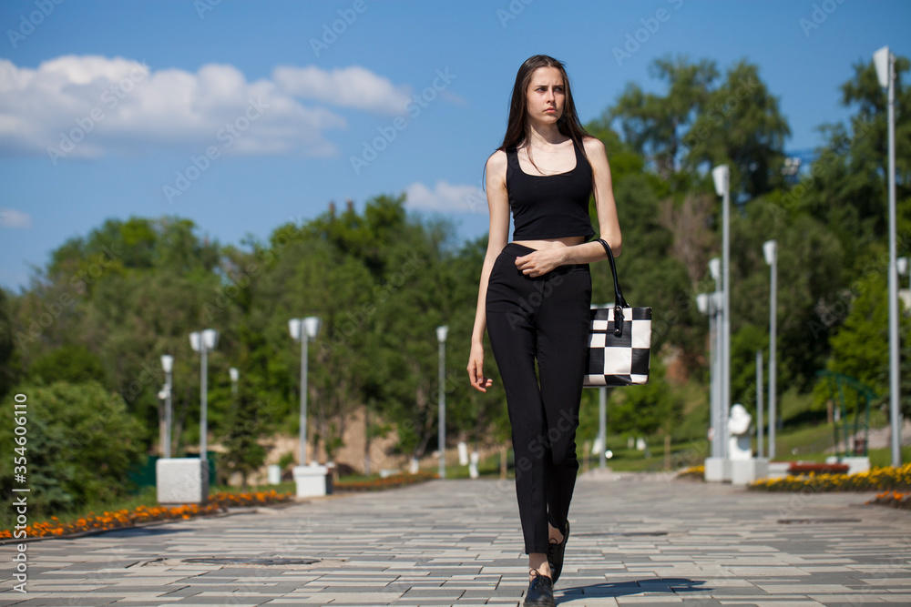 Young woman walking in summer park Young woman walking in summer park