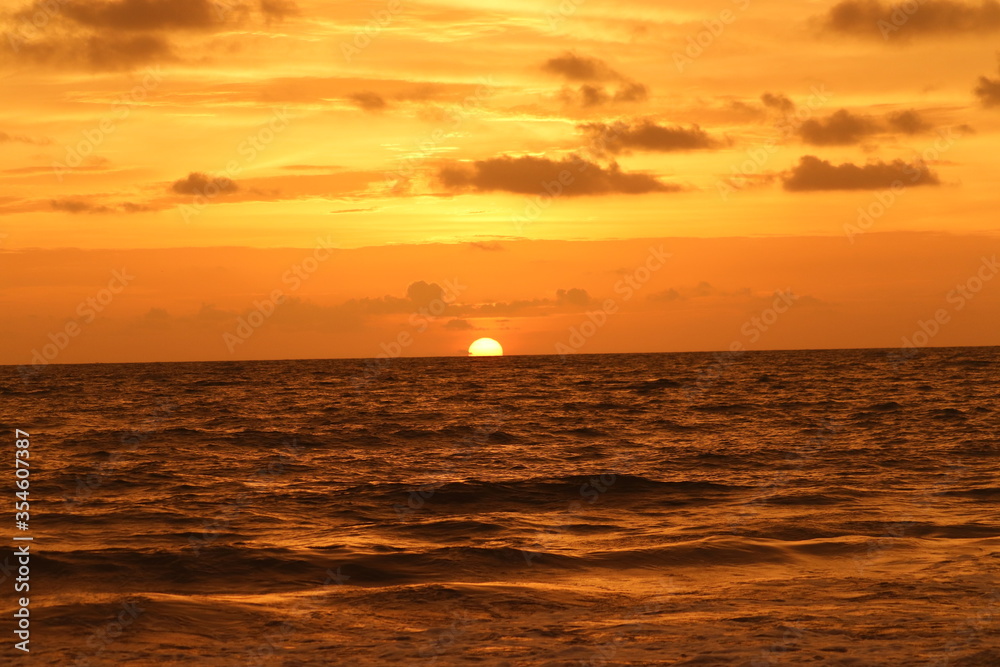 A beautiful sunset . The sun throwing its reds and oranges into the sky like a molten lava. A beautiful sunset . The sun throwing its reds and oranges into the sky like a molten lava.