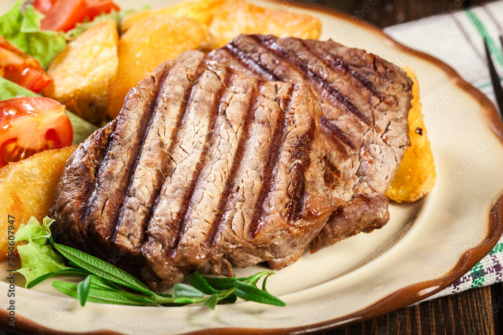 Succulent portions of grilled fillet mignon served with baked potatoes Succulent portions of grilled fillet mignon served with baked potatoes