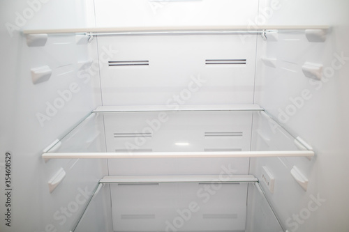 Close-up of Empty Refrigerator inside. Empty fridge shelves