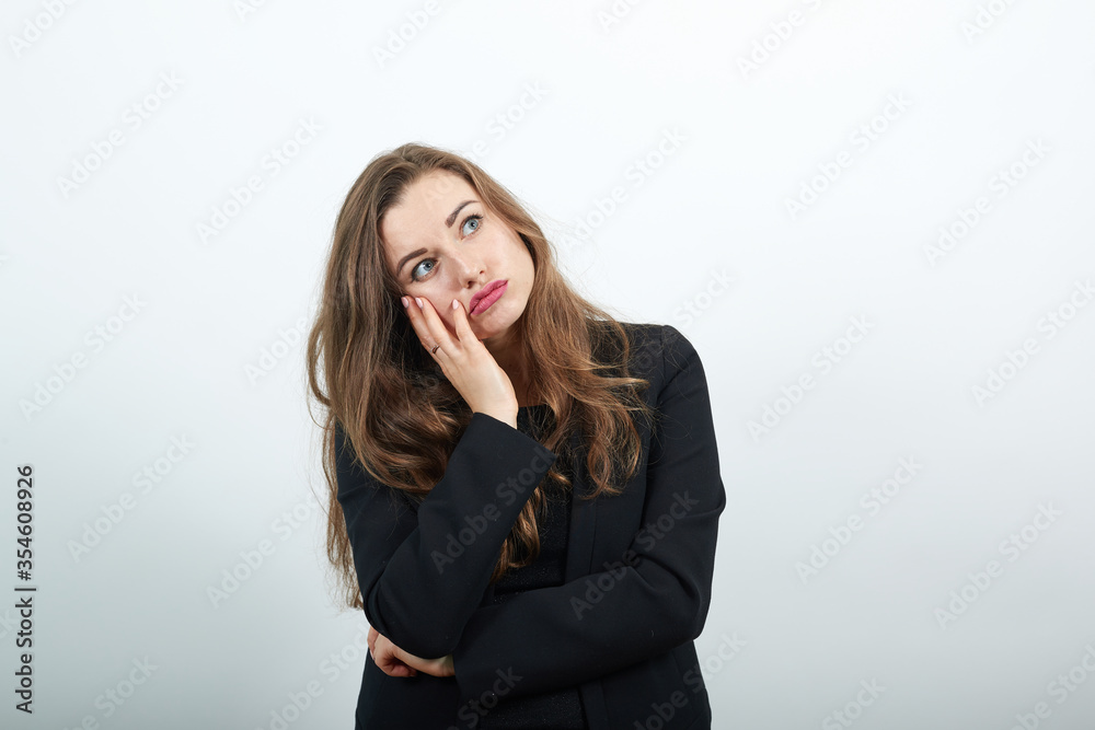 Leaned on her hand, falling asleep sad young depressed difficulty and emotional problems, young attractive woman brunette in a black t-shirt, sweater on white background Leaned on her hand, falling asleep sad young depressed difficulty and emotional problems, young attractive woman brunette in a black t-shirt, sweater on white background