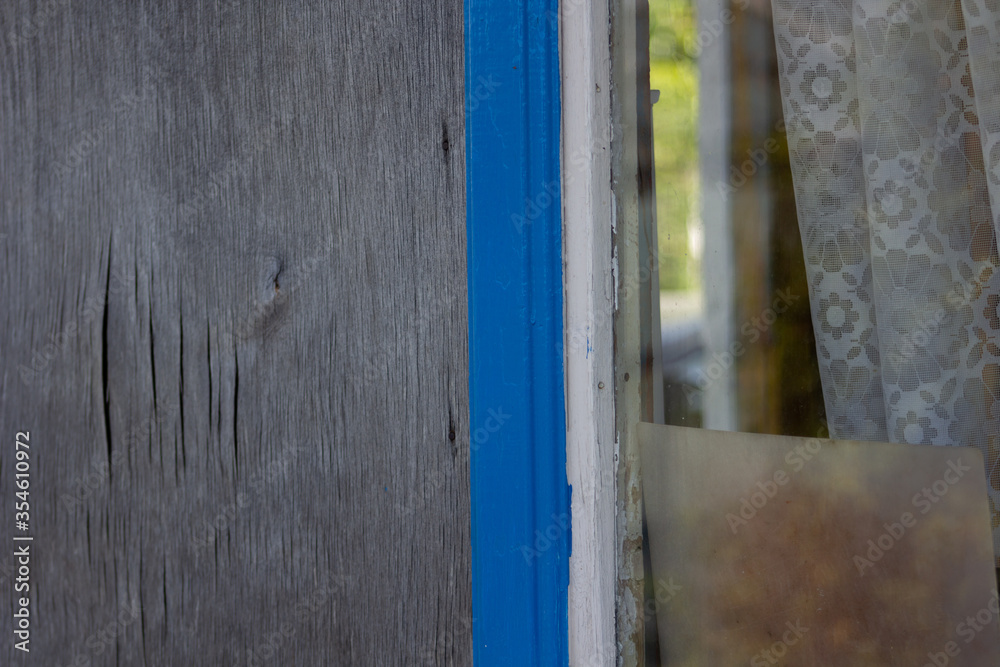 old wooden door with blue shutters