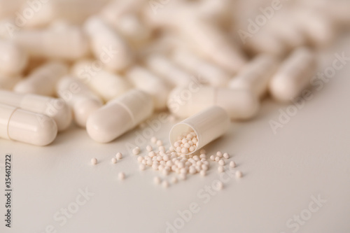 Macro photo of white pills that lying on paper