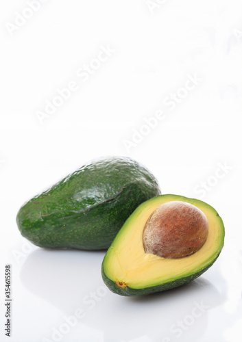 Healthy lifestyle concept. Avocados whole and half isolated on white background.