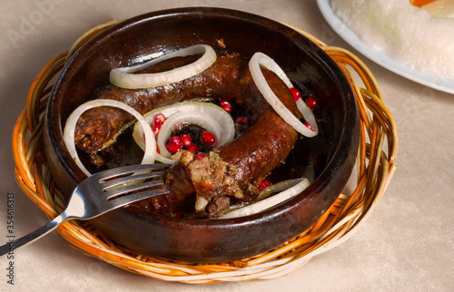 Georgian traditional food and cuisine Kupati and red wine, ghomi and cheese. photo