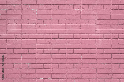 Dusty rose colored painted brick wall, creative copy space, horizontal aspect