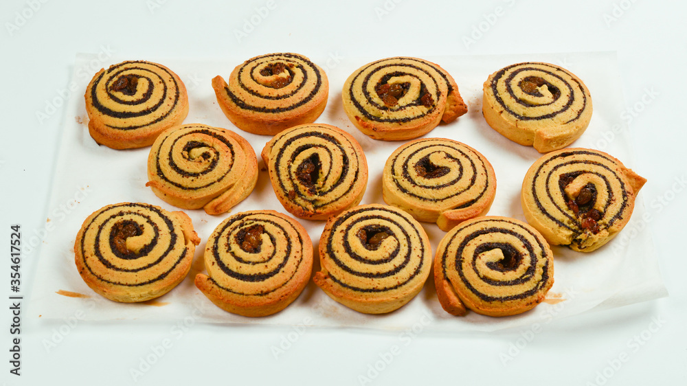 Baked cookies with raisins and poppy seeds isolated on white background.