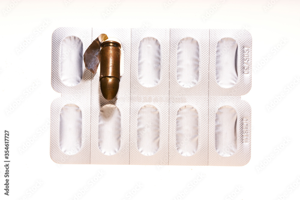 Obraz premium medicines and bullets on white background