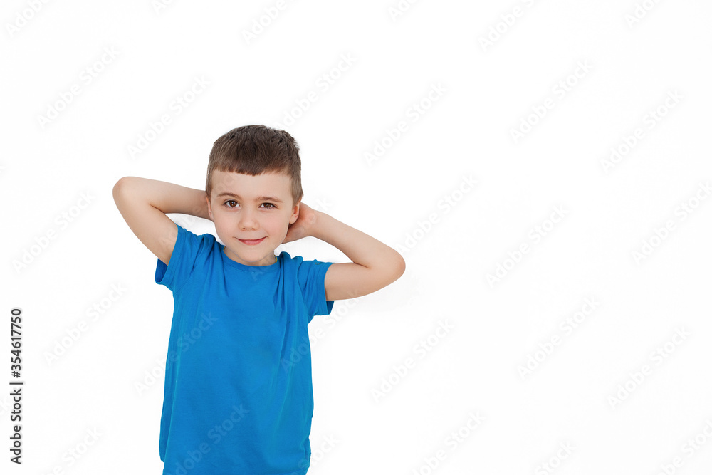 Relaxed child in a blue t-shirt on a white background, isolated Relaxed child in a blue t-shirt on a white background, isolated