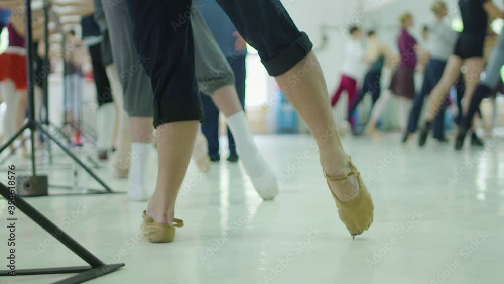Editorial slow motion shot of ballet dancer in class during practice. Warm-up Editorial slow motion shot of ballet dancer in class during practice. Warm-up