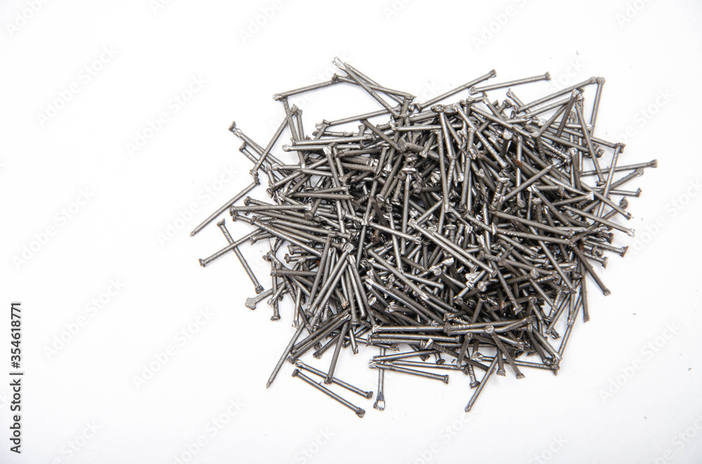 Nail. A pile of nails on a white background in macro. for text. Construction nails Nail. A pile of nails on a white background in macro. for text. Construction nails